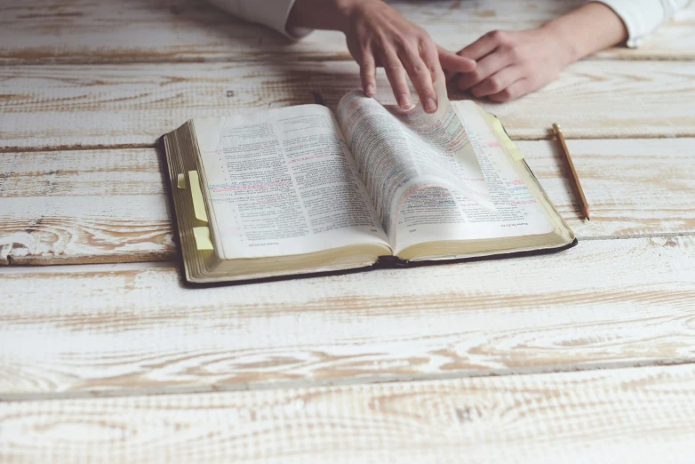 a woman is doing her job with an open bible