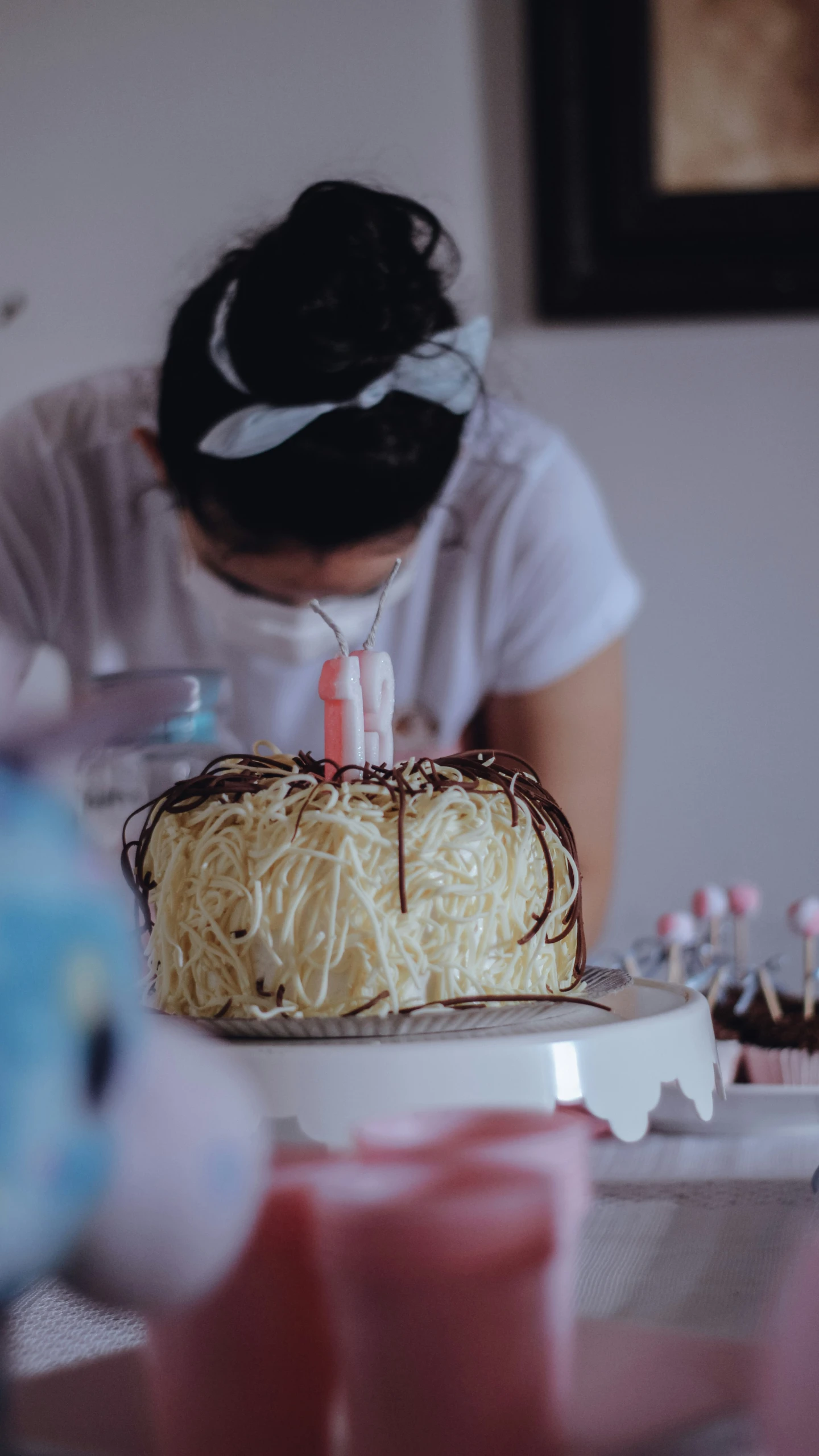 the girl is sitting in front of her cake