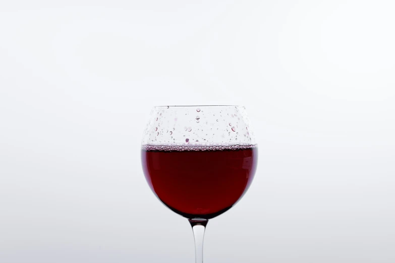the wine glass has an almost empty liquid