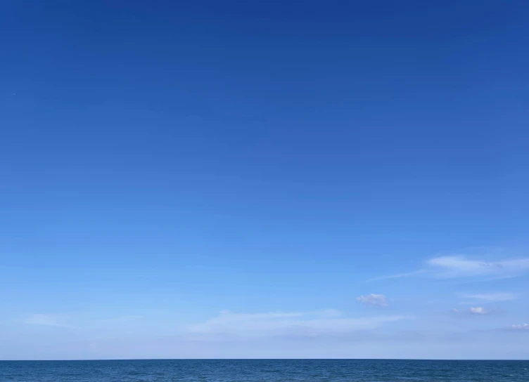 boats in the distance on a calm blue ocean