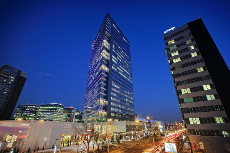 the tall buildings are illuminated at night time