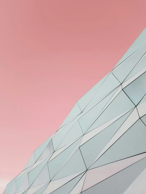 a large building sitting under a pink sky