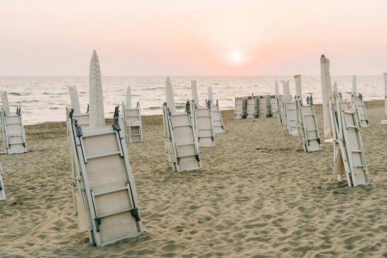 several chairs on the sand at the beach