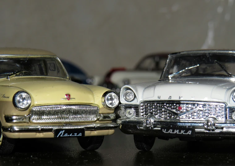 two model cars sit together on a table