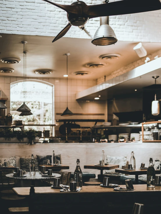 a kitchen filled with lots of wooden furniture and a ceiling mounted ceiling fan