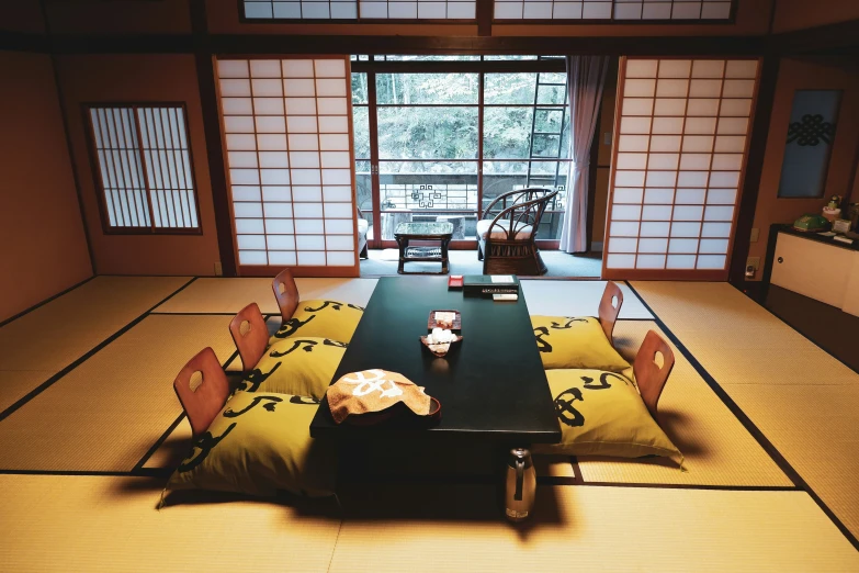 a room that has tatami mats and wooden tables