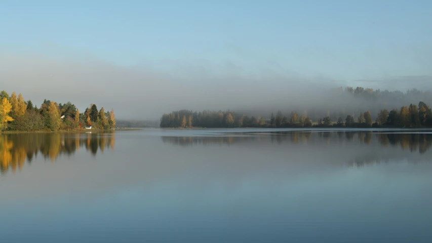 an image of a lake with fog in the background