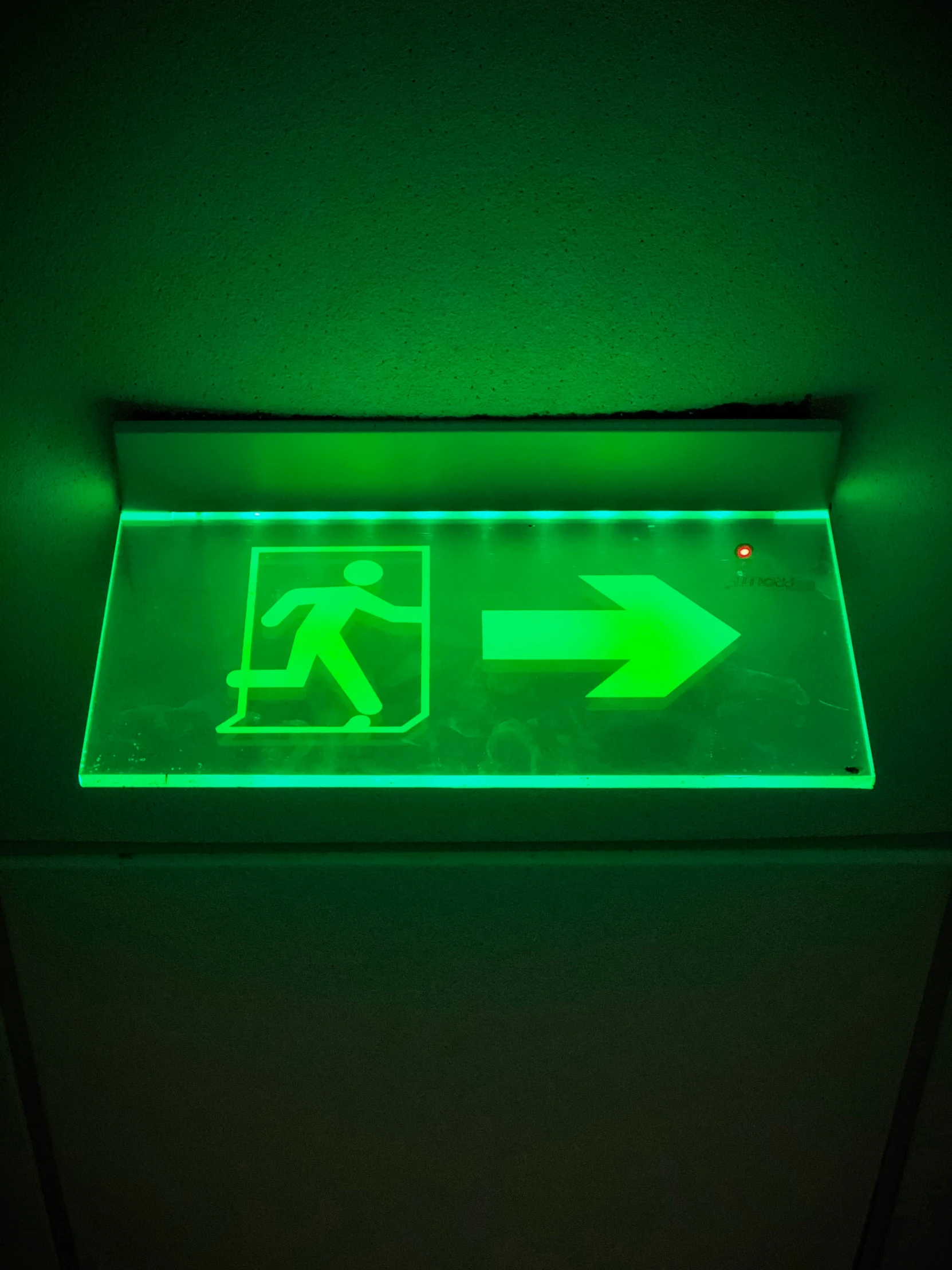 a illuminated sign in the corner for a walk