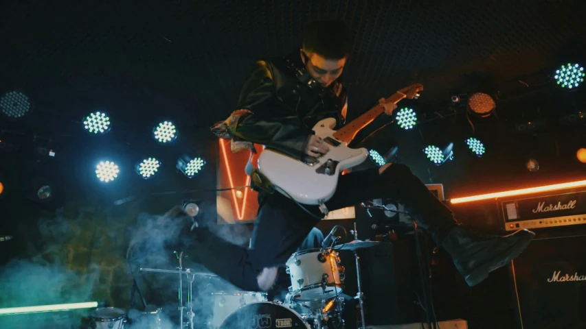 a man that is sitting down with a guitar