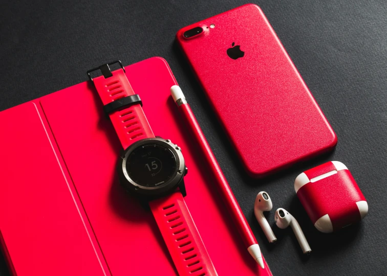 a couple of red ipods with headphones on top