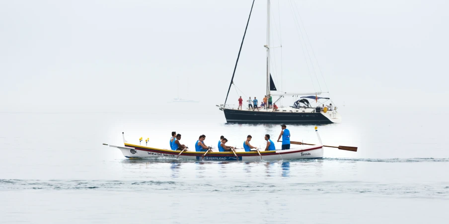 the people are riding in a row boat