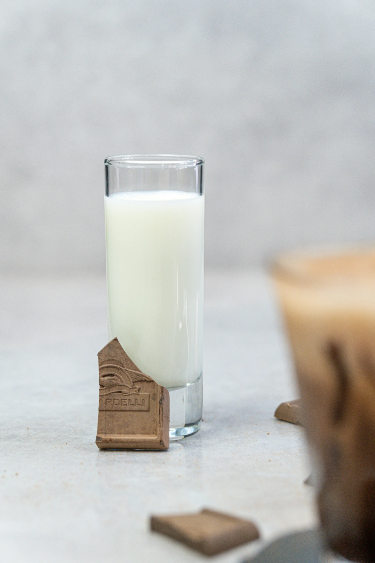 a glass of milk sits beside some brown items