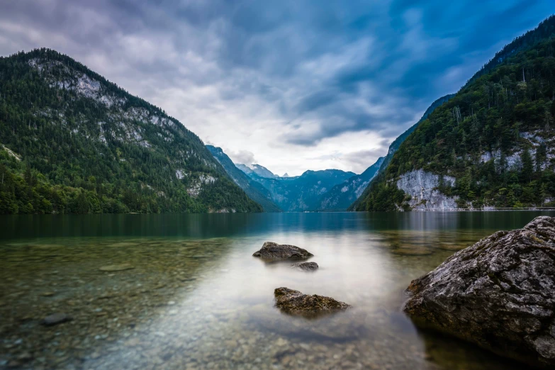 the shore of a large lake surrounded by mountains