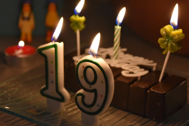chocolate cake with candles and the number nine surrounded by other icing and decorations