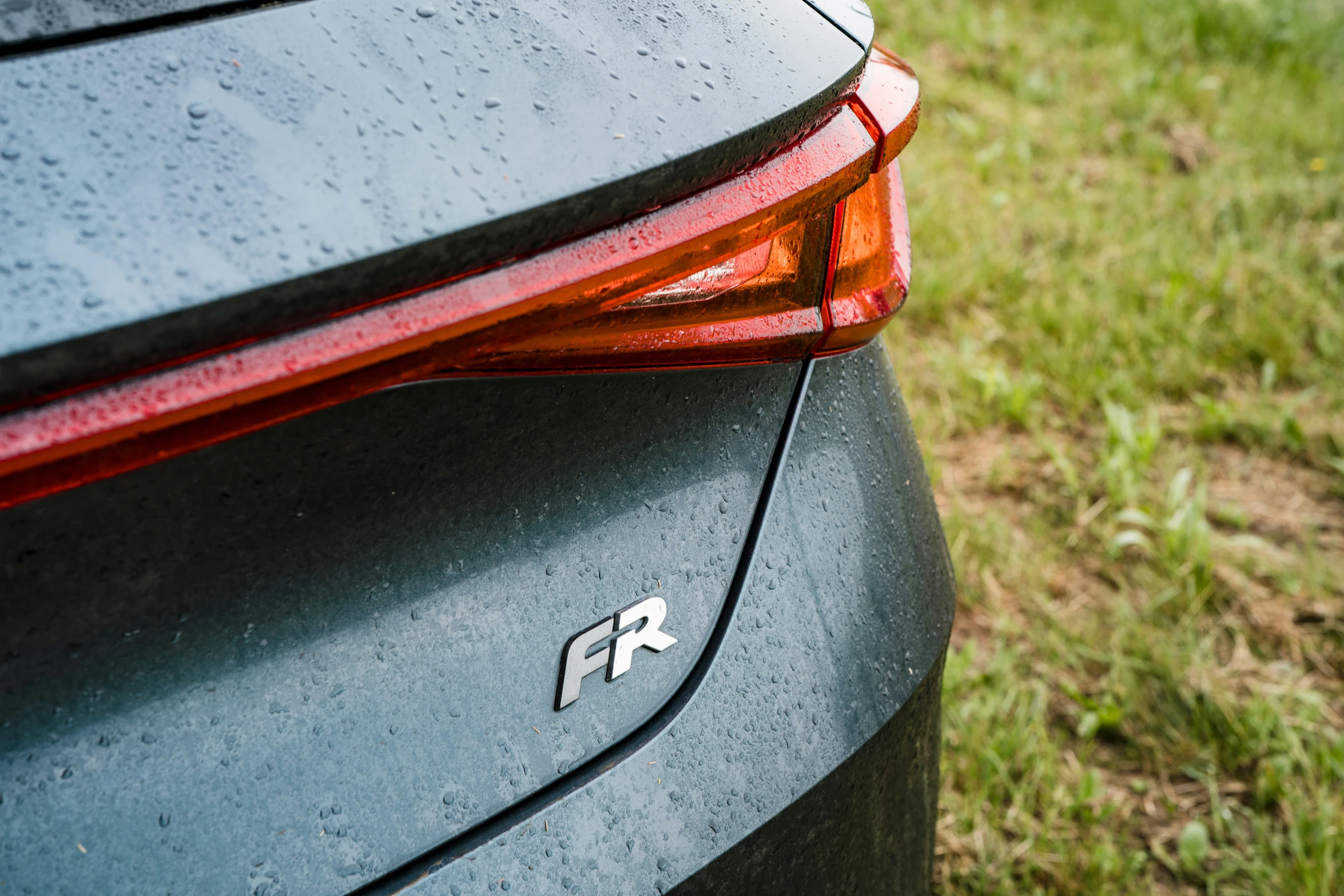 a close up image of the side bumper of a gray car