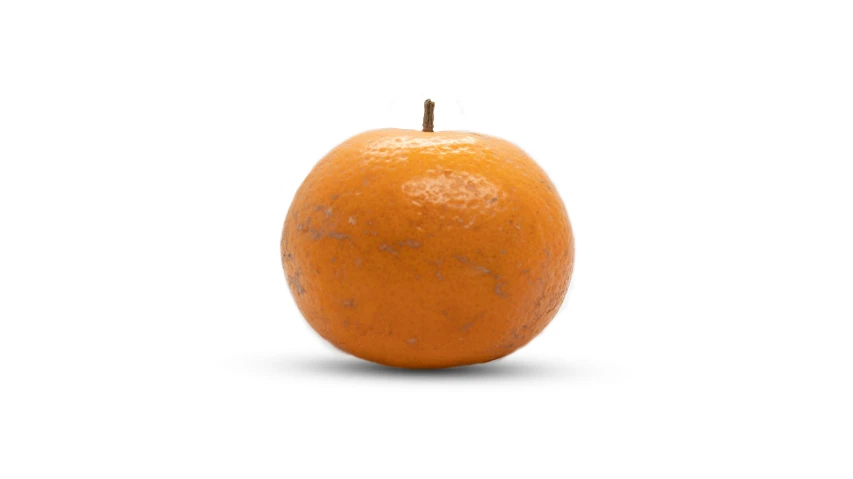 an orange sitting on top of a white surface