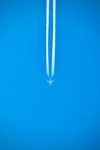 the two planes are flying in the sky together