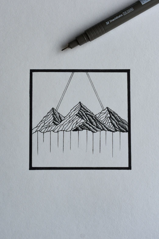 a drawing of mountains is seen from behind a white surface