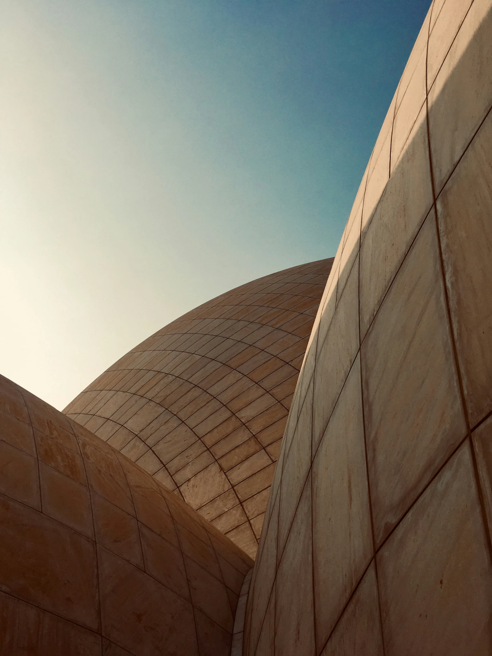 the view from outside a building, looking up at an odd shaped structure