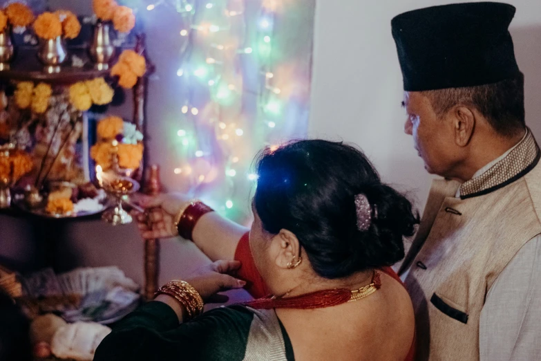 a man and woman standing near each other with flowers on a table