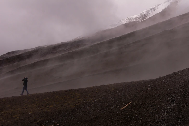 a person is walking in the mountain alone