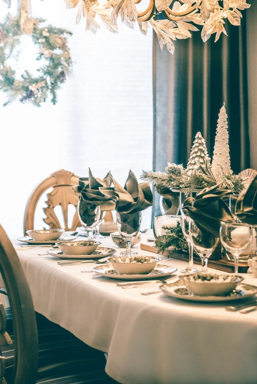 a table set for christmas dinner with plates and dishes