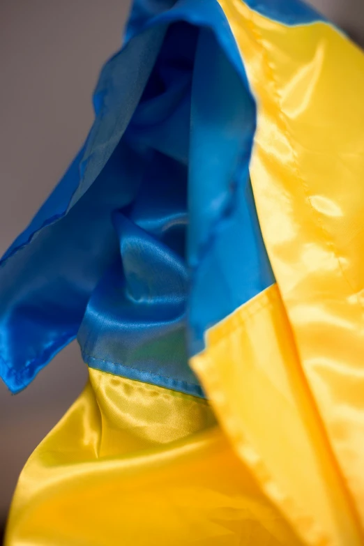 blue and yellow satin material in a bag