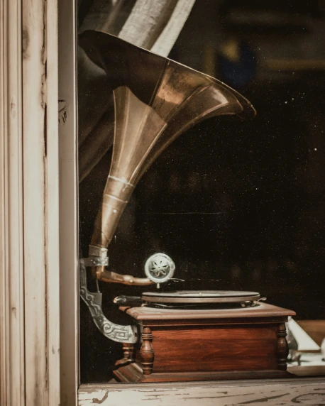 a record player and a trumpet in a window