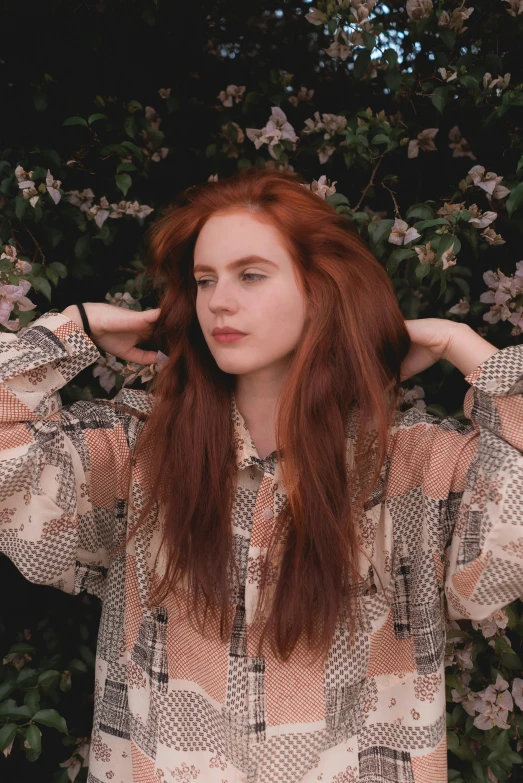 a woman with red hair and white flowers