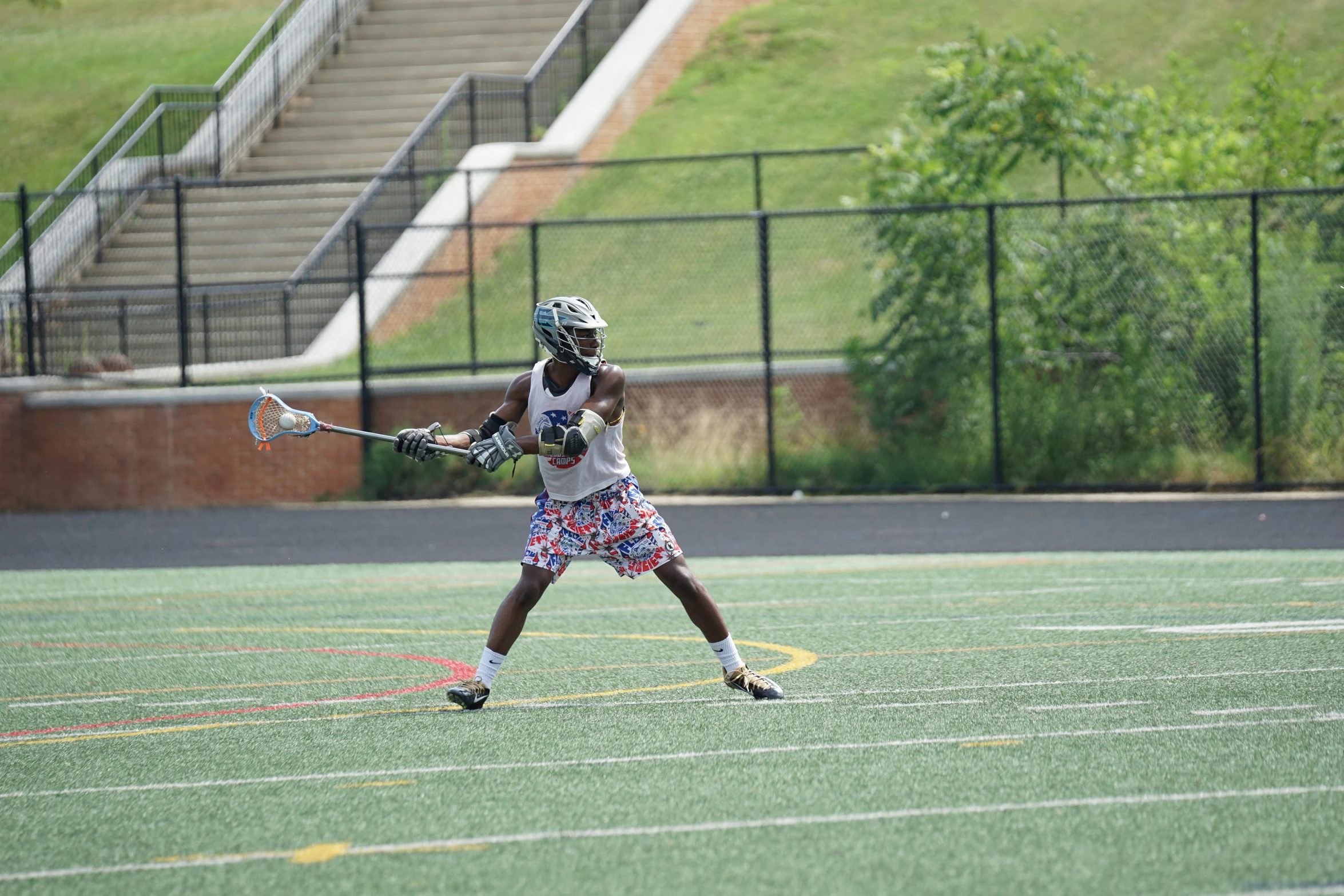 an image of a male lacrosse player going for the ball