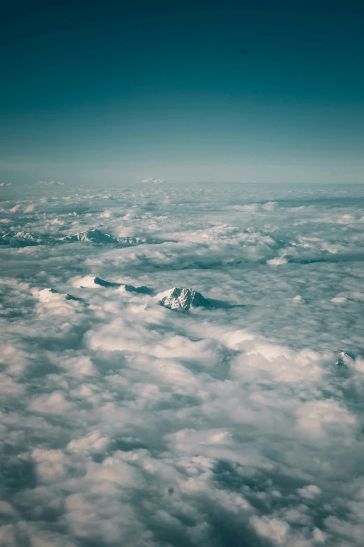 a blue sky that has clouds and a mountain