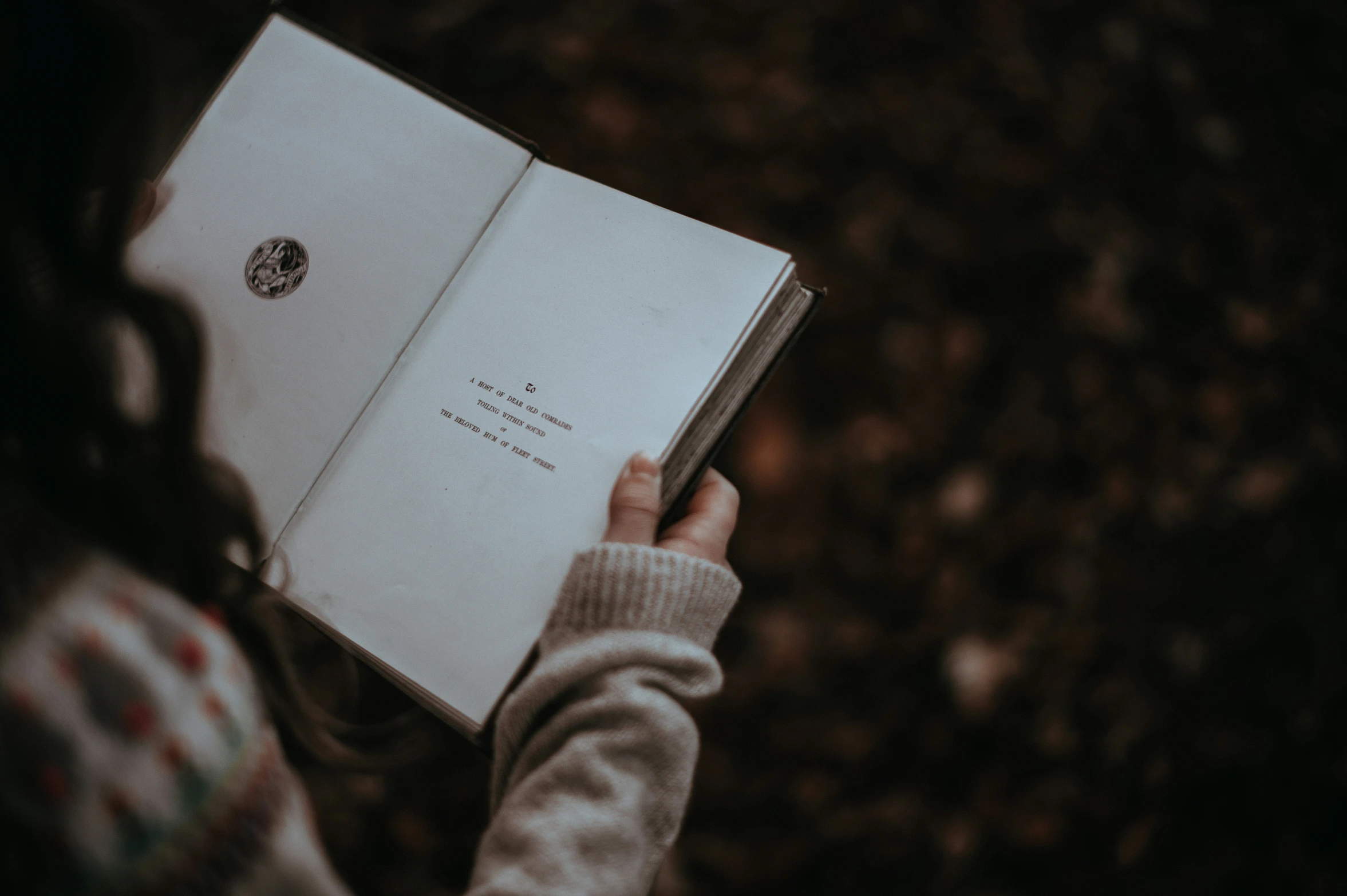 someone holding an open book that reads'a love letter to my mother '