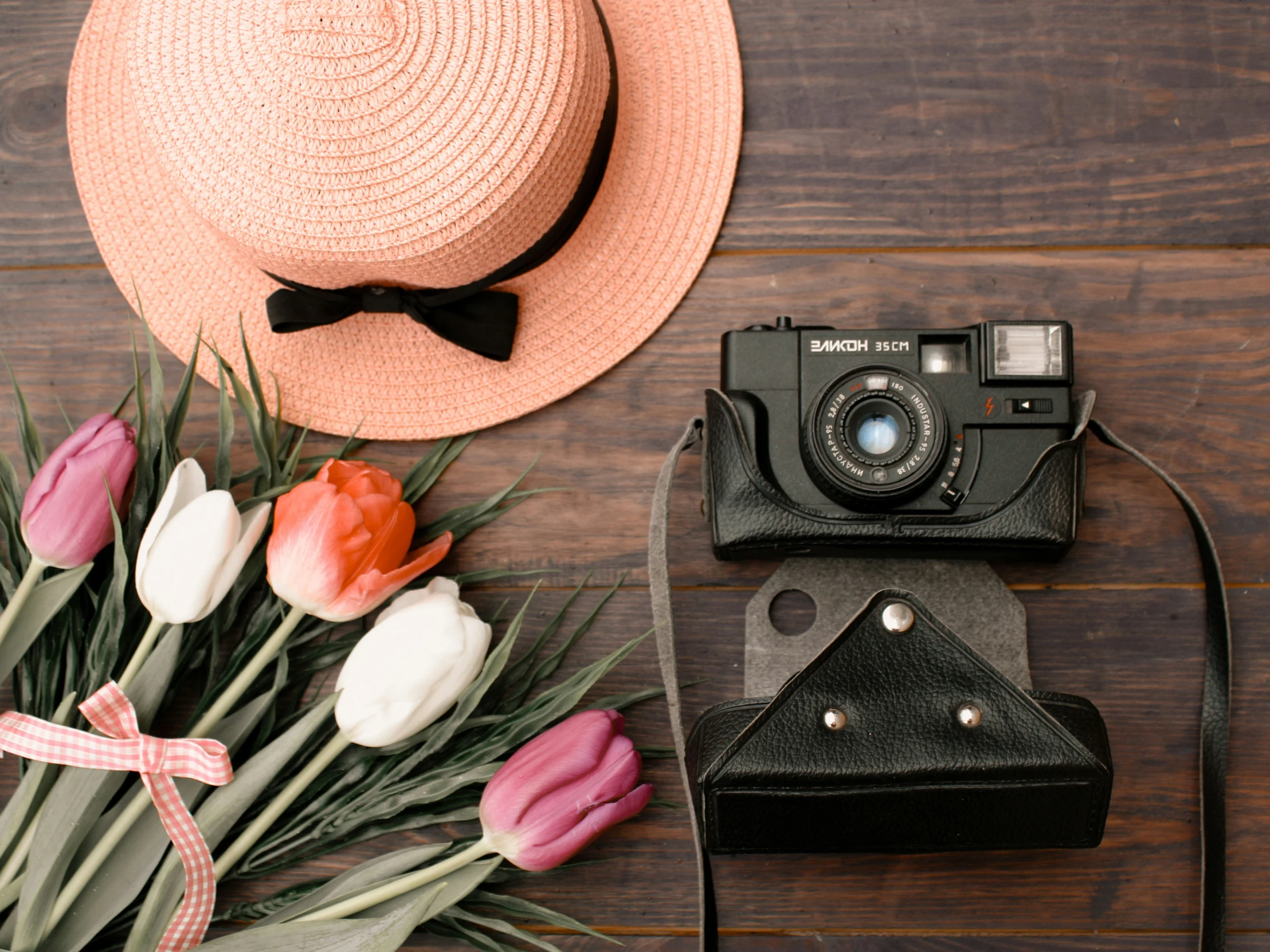 a bow tie and hat, camera, flower and phone