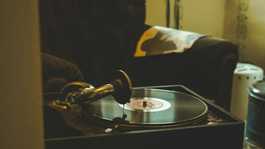 turntable and gold record player sitting on the corner