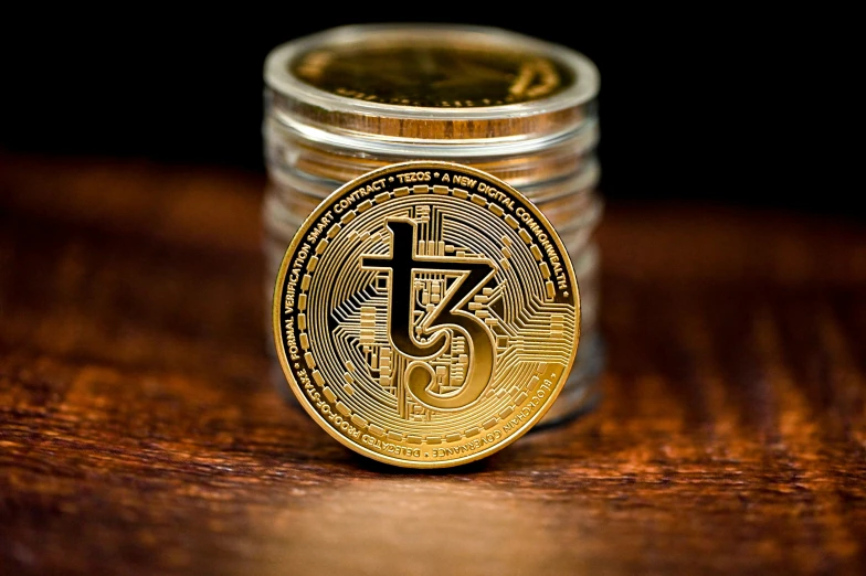 a tiny jar with a gold bit coin inside