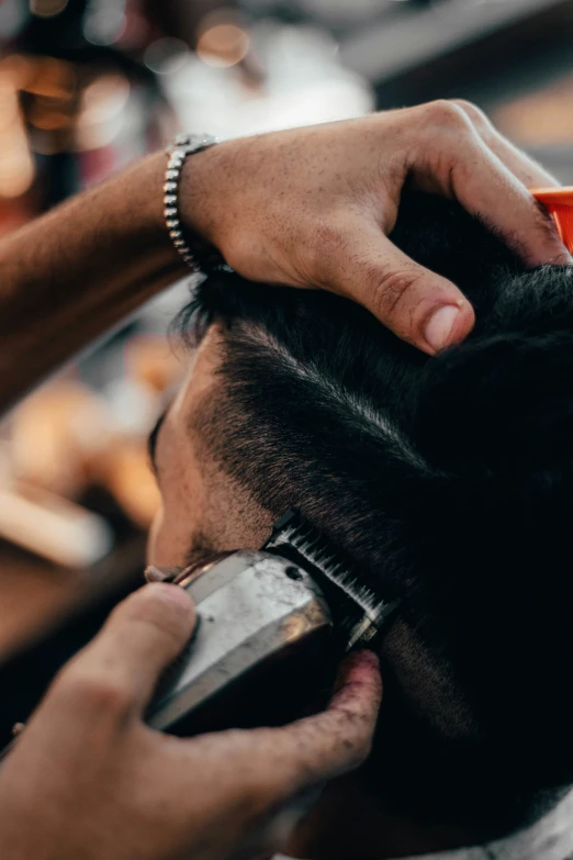 the barber has a glass of hair gel