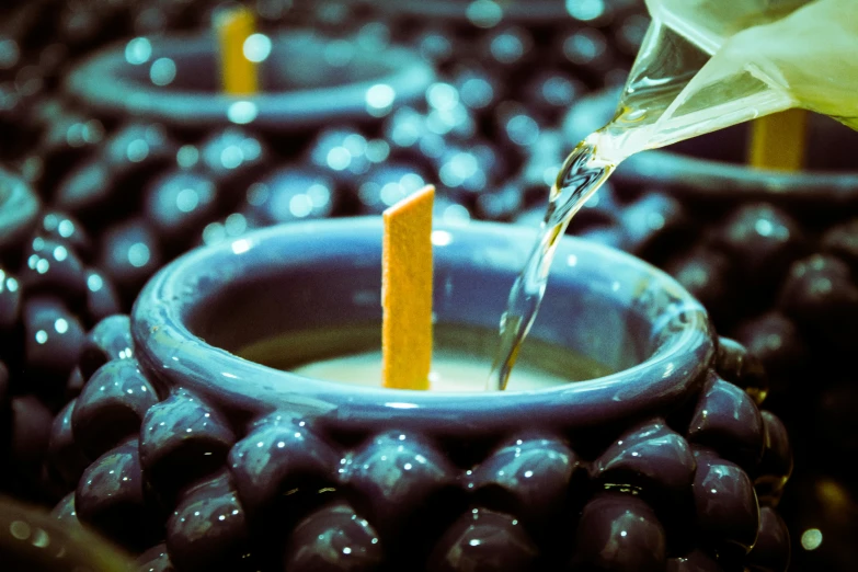 a person pours sugar into a glass