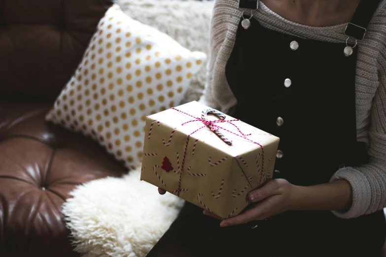 a woman holding a present with one of her hands