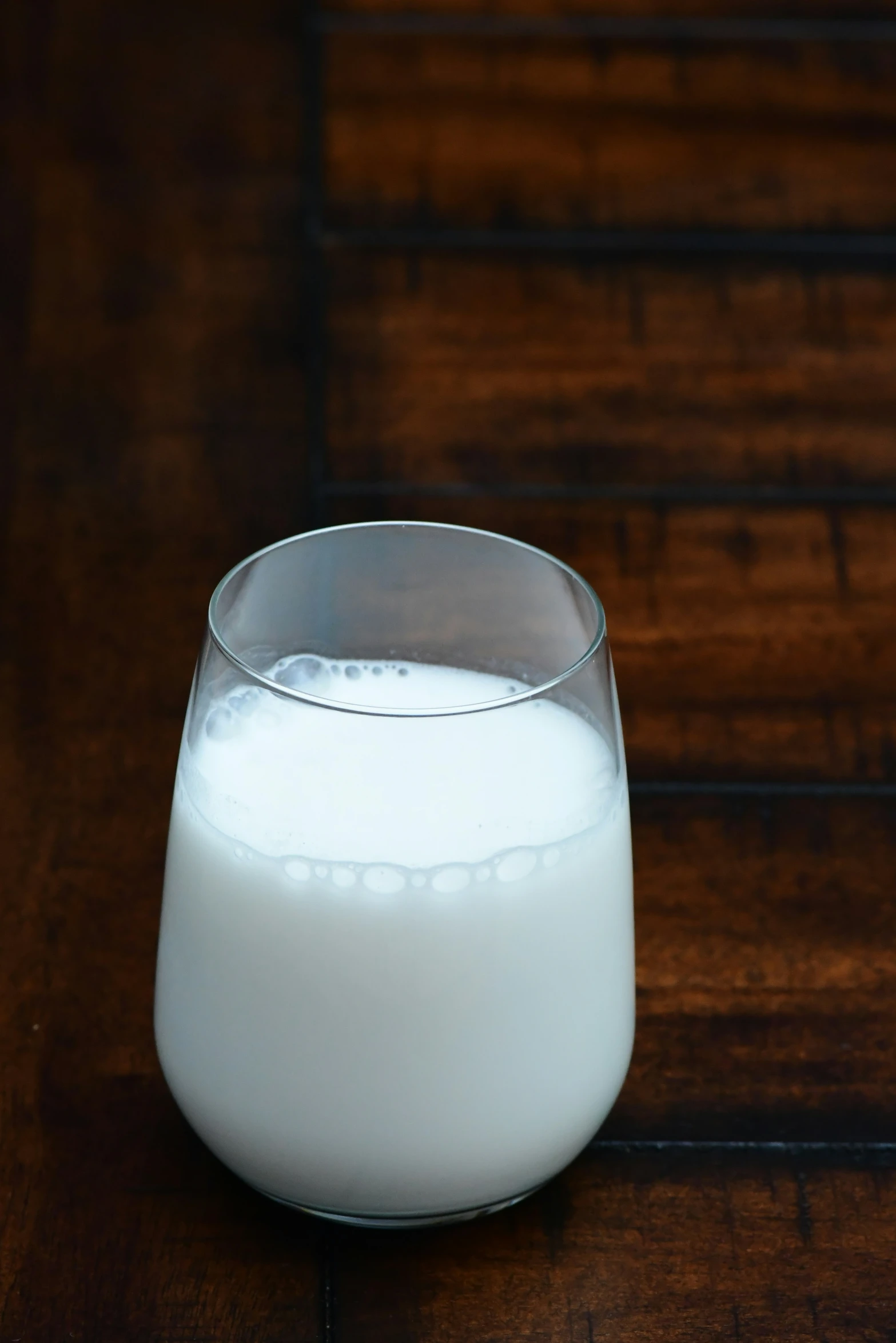 a glass of milk sits on a table