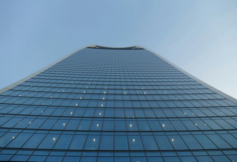 a tall building with many windows under the sky