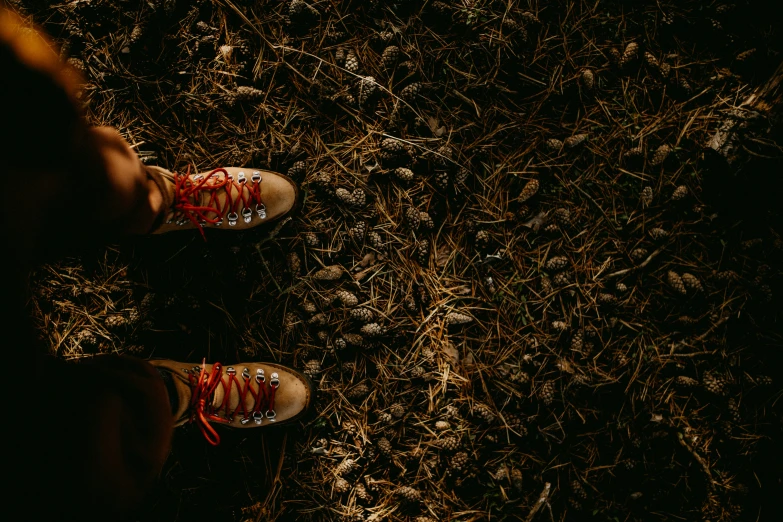 a person standing in the dirt with their shoes on