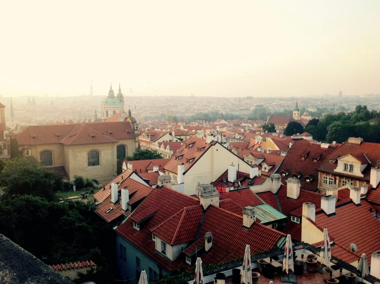 a bunch of old rooftops and buildings in the sunset