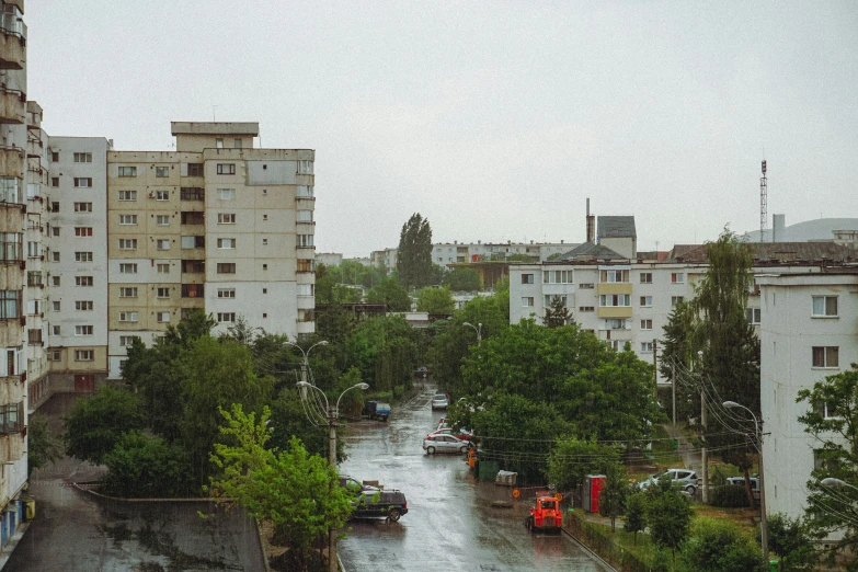 some cars parked in a small wet road