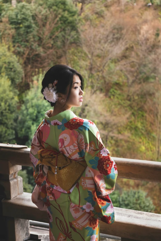 woman in kimono looking out at trees