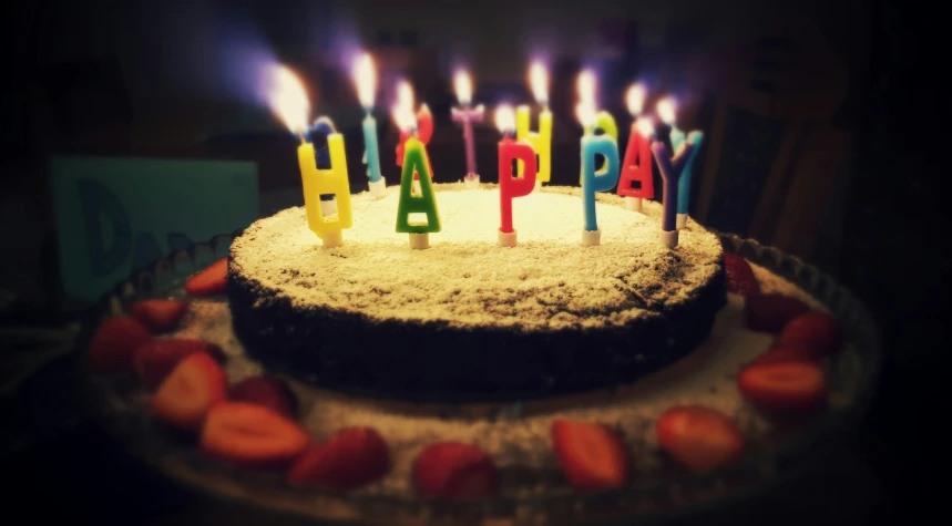 a birthday cake with the candles lit up