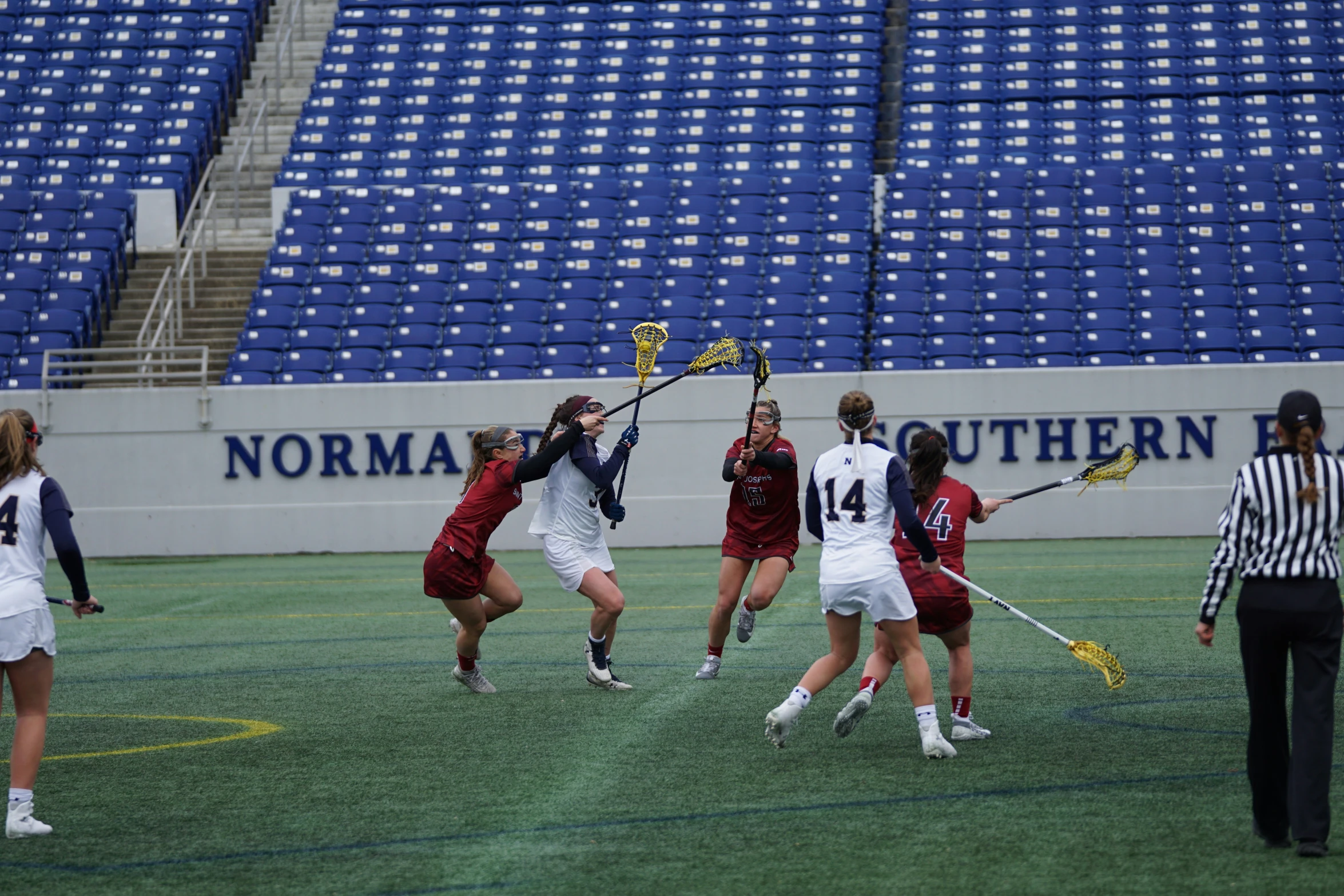 women playing field hockey during an indoor game