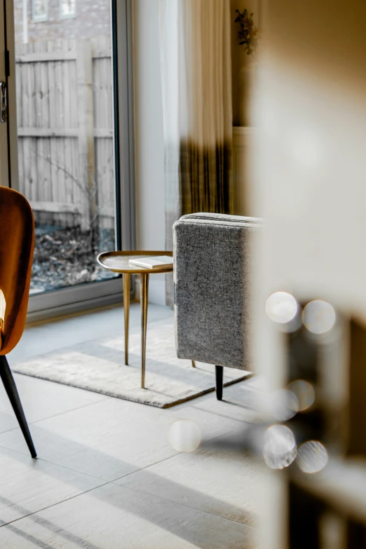 a room that has a large glass door and two chairs with matching fabric covers