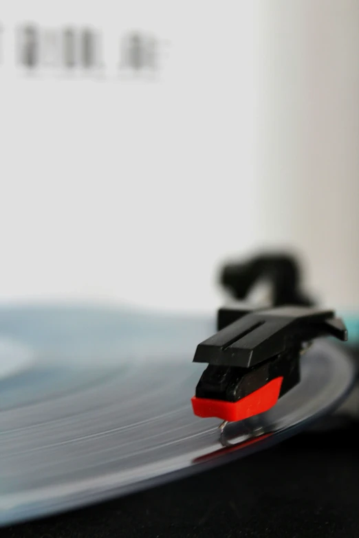 a record player sits on the table in front of a blurred background