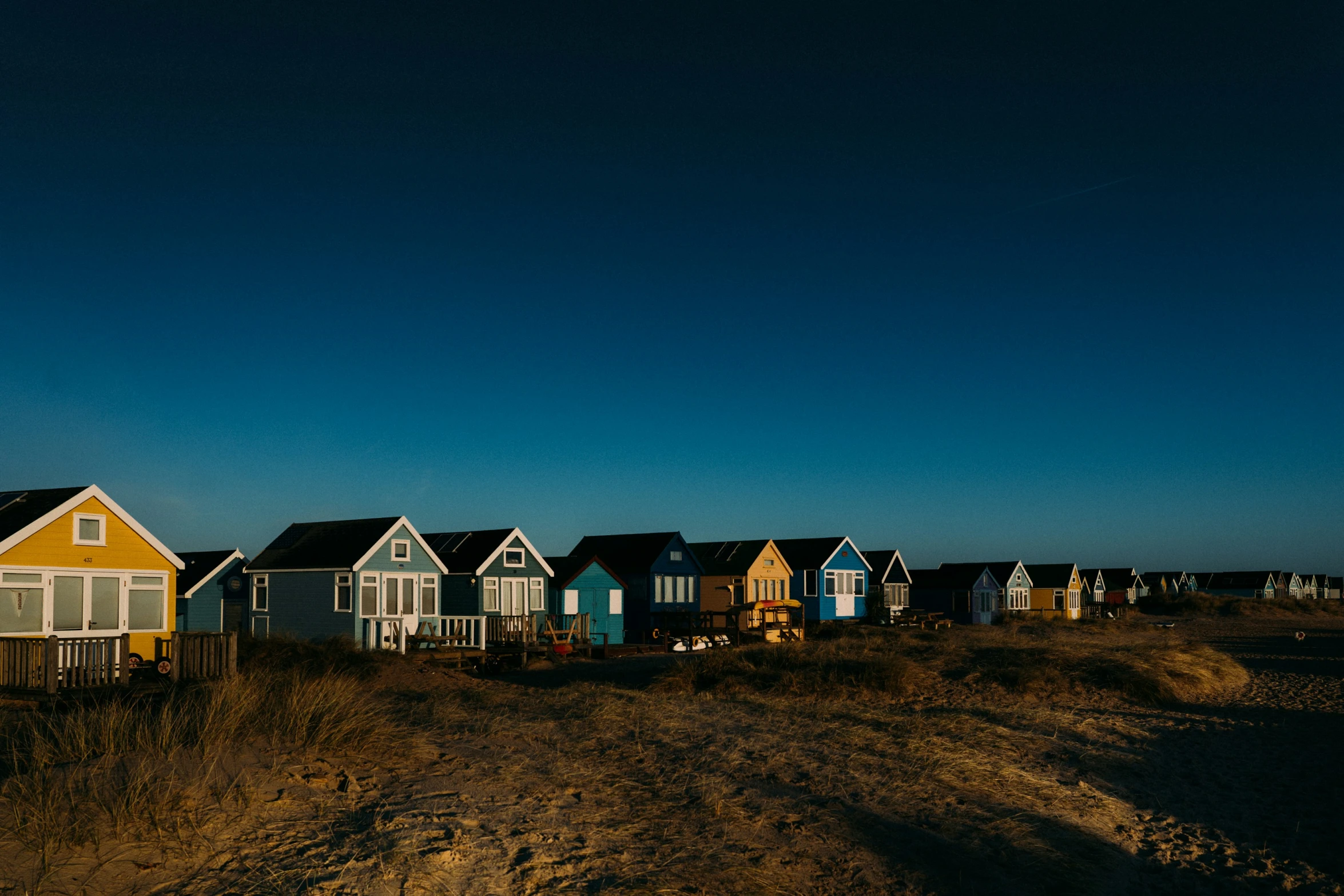 a bunch of houses sit in the dirt