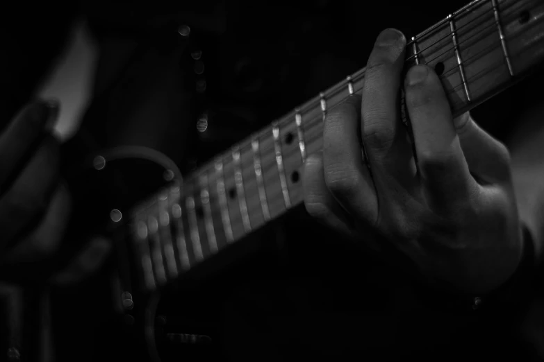 a close up of a person playing an electric guitar